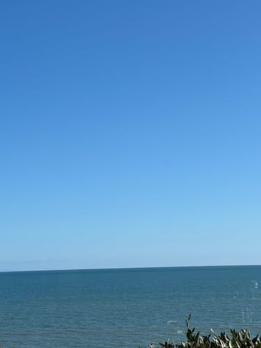 Reviewer's view of the sea through a clean bi-fold glass door, highlighting the effect of KoalaCloth XXL Bundle
